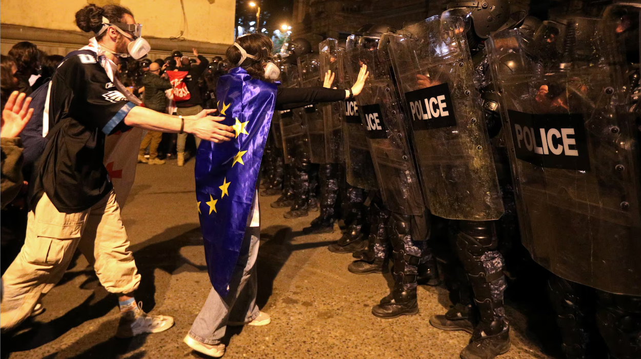Protesters face police at a Tbilisi rally against the 