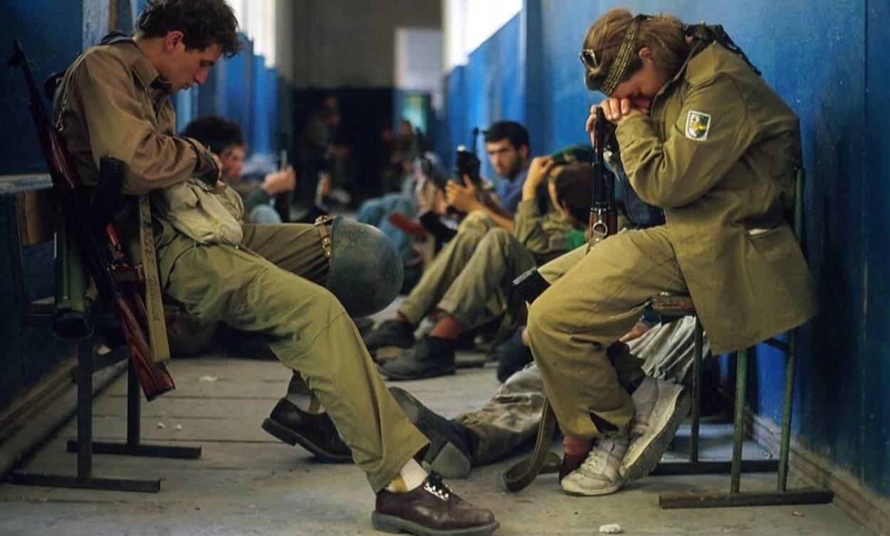 Abkhazian fighters sit in a hallway. September, 1993. Photo by Malcolm Linton.