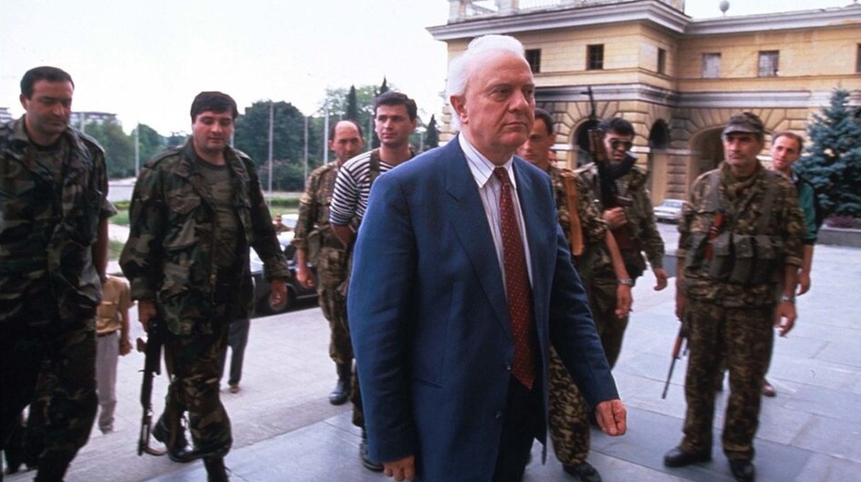 Eduard Shevardnadze stands with soldiers at the parliament building in Sukhum.