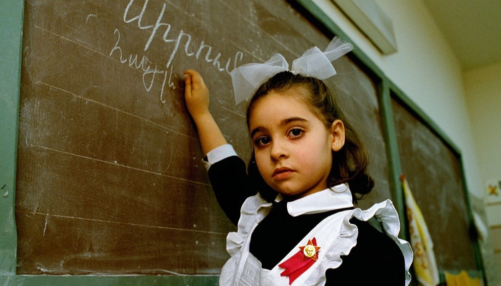 An Armenian girl writes on the chalkboard at school (1988) An Armenian girl writes on the chalkboard at school