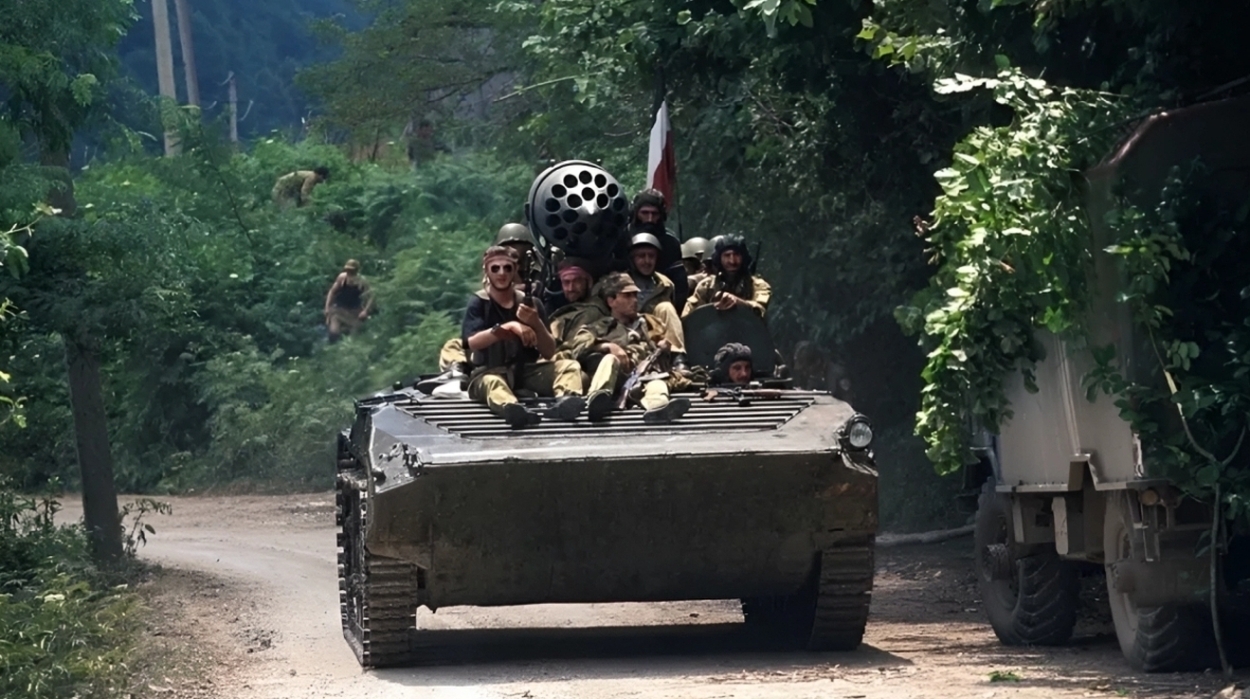 A Georgian armored vehicle drives down a road. July, 1993. Sukhum, Abkhazia