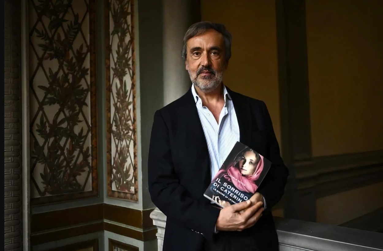 Carlo Vecce holds a copy of his book in Florence on Tuesday. Vecce is a specialist in da Vinci's life and work
