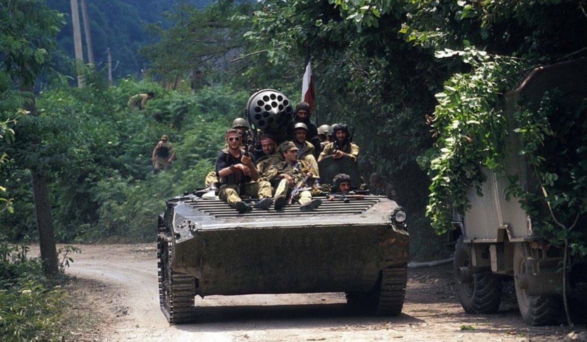 A Georgian armored vehicle drives down a road. July, 1993. Sukhum, Abkhazia