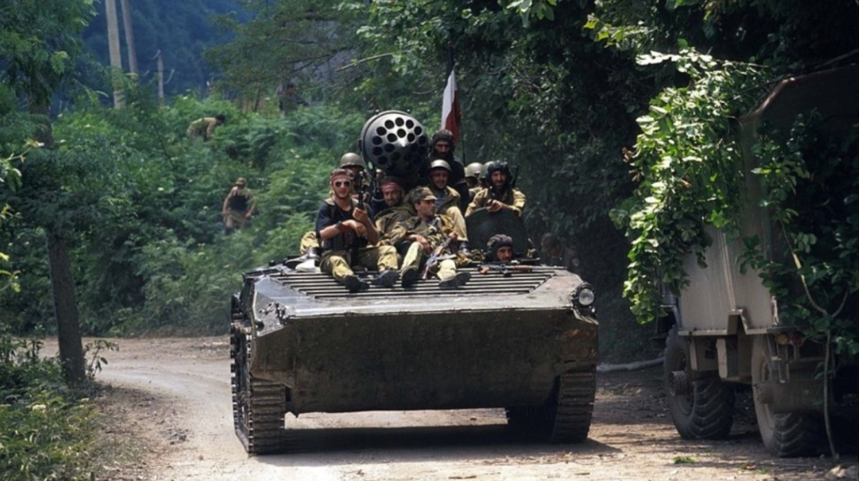 A Georgian armored vehicle drives down a road. July, 1993. Sukhum, Abkhazia