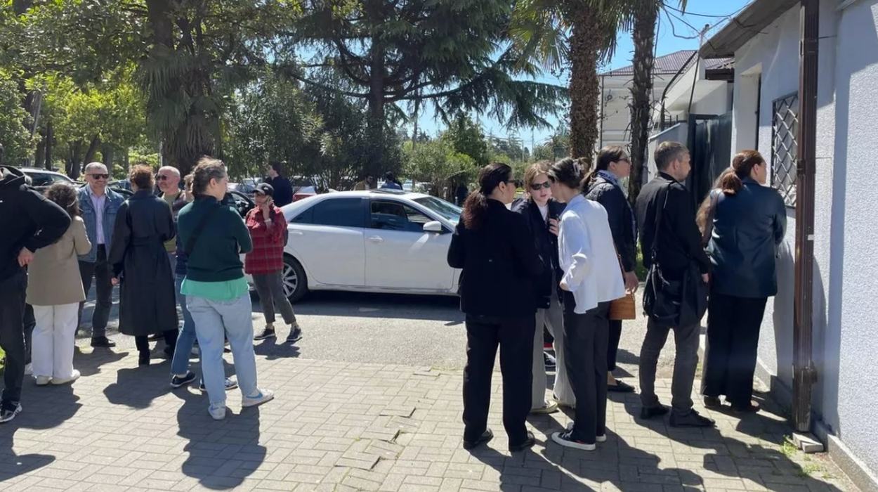 People gather outside the police department building in support of the detained activists.