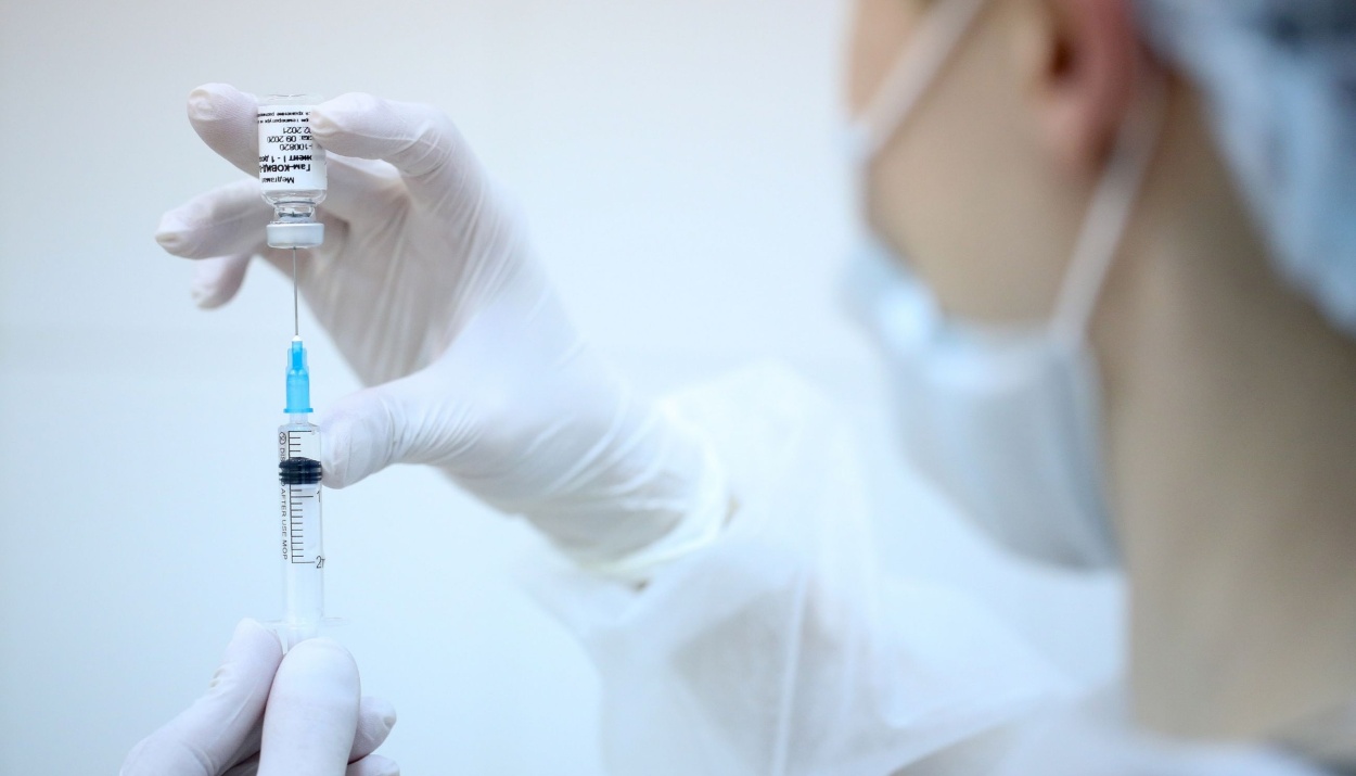 A heath worker draws the Sputnik V vaccine from a vial during a post-registration phase trial in Moscow, on Sept. 23.