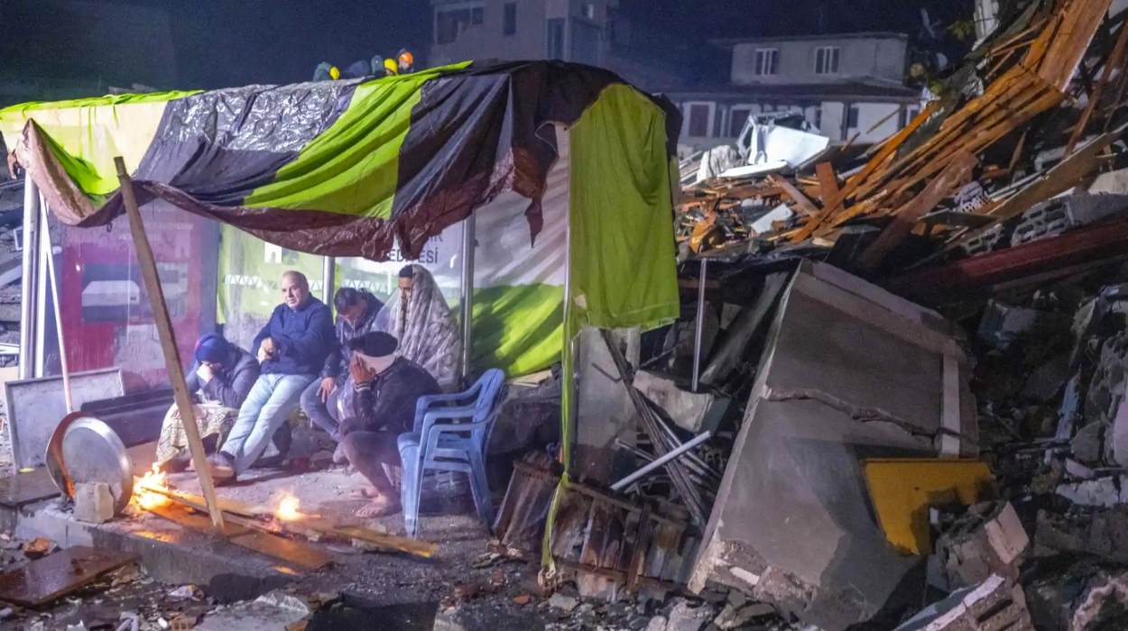Survivors in a makeshift shelter amid the rubble in Hatay, Turkey. Photo: Bülent Kılıç/AFP Survivors in a makeshift shelter amid the rubble in Hatay, Turkey. Photo: Bülent Kılıç/AFP
