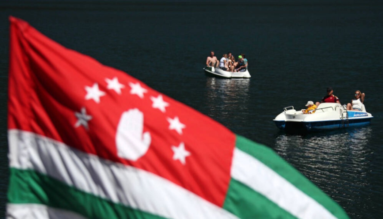 Russian tourists enjoy summer holidays by Lake Ritsa in Abkhazia