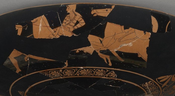 This Greek cup, dating from around 510 B.C., depicts an Amazon warrior on a horse. Scholars suggest wording on the vase names the woman Worthy of Armor in ancient Circassian. PHOTOGRAPH BY THE J. PAUL GETTY MUSEUM This Greek cup